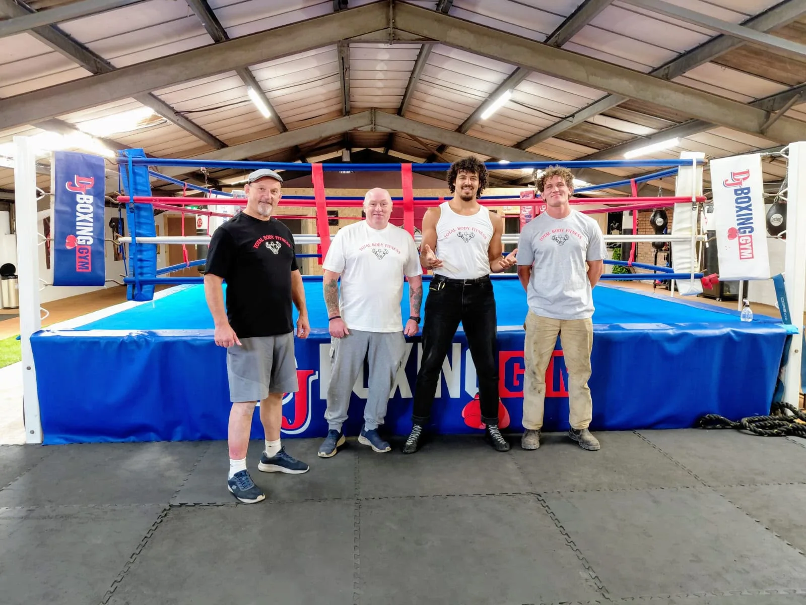 The coaching team at Total Body Fitness in front of the boxing ring